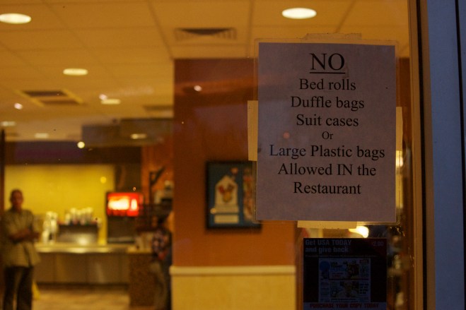 Sign prohibiting entrance to individuals perceived to be homeless at local fast-food restaurant in the downtown area of Phoenix, Arizona.