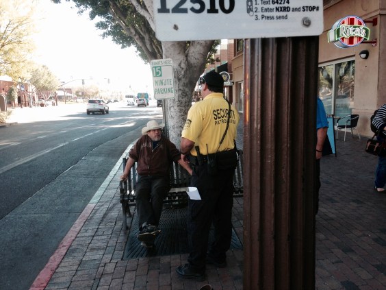 Man perceived to be homeless is asked to leave the bus station premises by security personnel of the Tempe, Arizona downtown business center. 